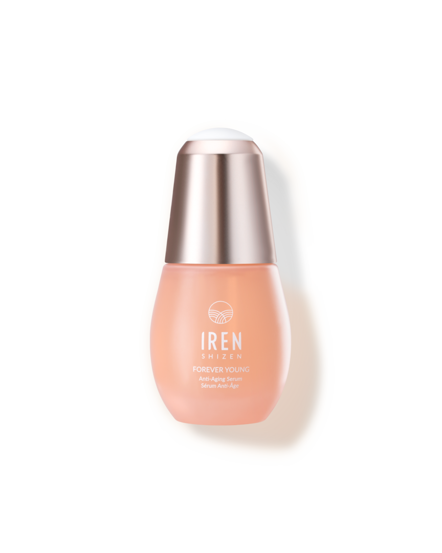 A bottle of customized Japanese skincare - FOREVER YOUNG Anti-Aging Serum by IREN Shizen on a black background.