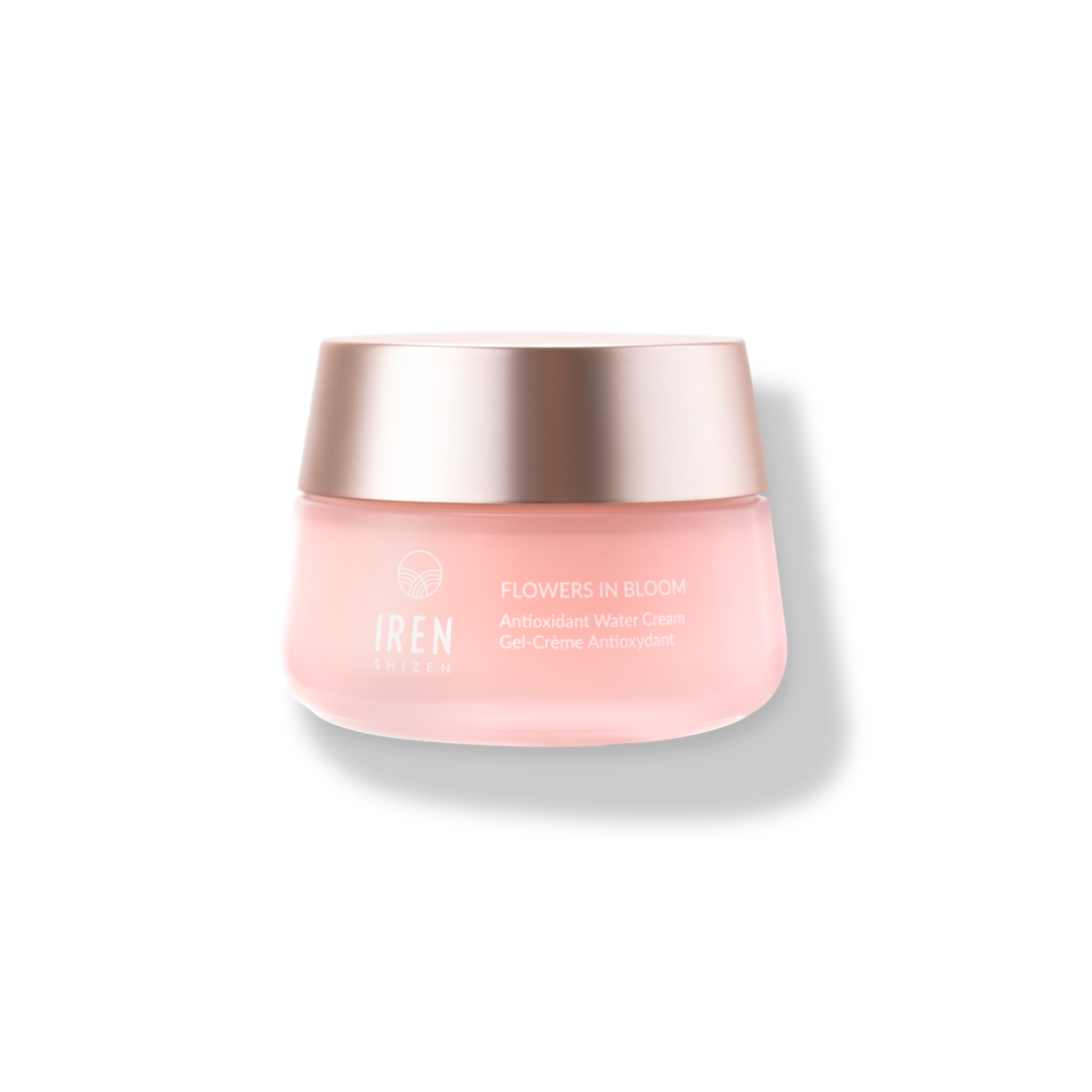 A jar of FLOWERS IN BLOOM Antioxidant Water Cream by IREN Shizen, designed for sensitive skin, featuring a pink container and a metallic cap, isolated on a white background.