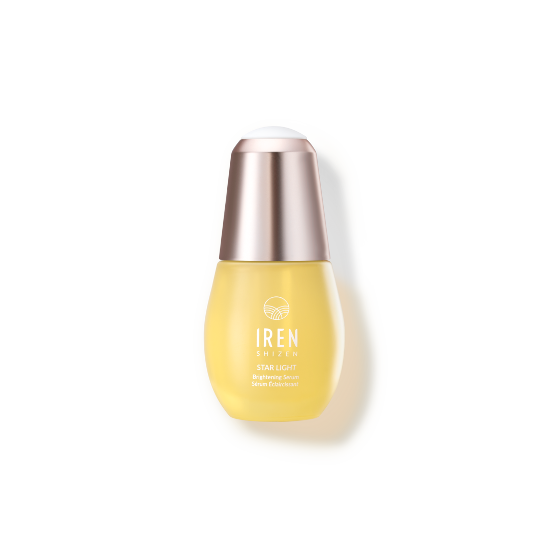 A bottle of IREN Shizen Serum, a Japanese skincare product, on a black background.